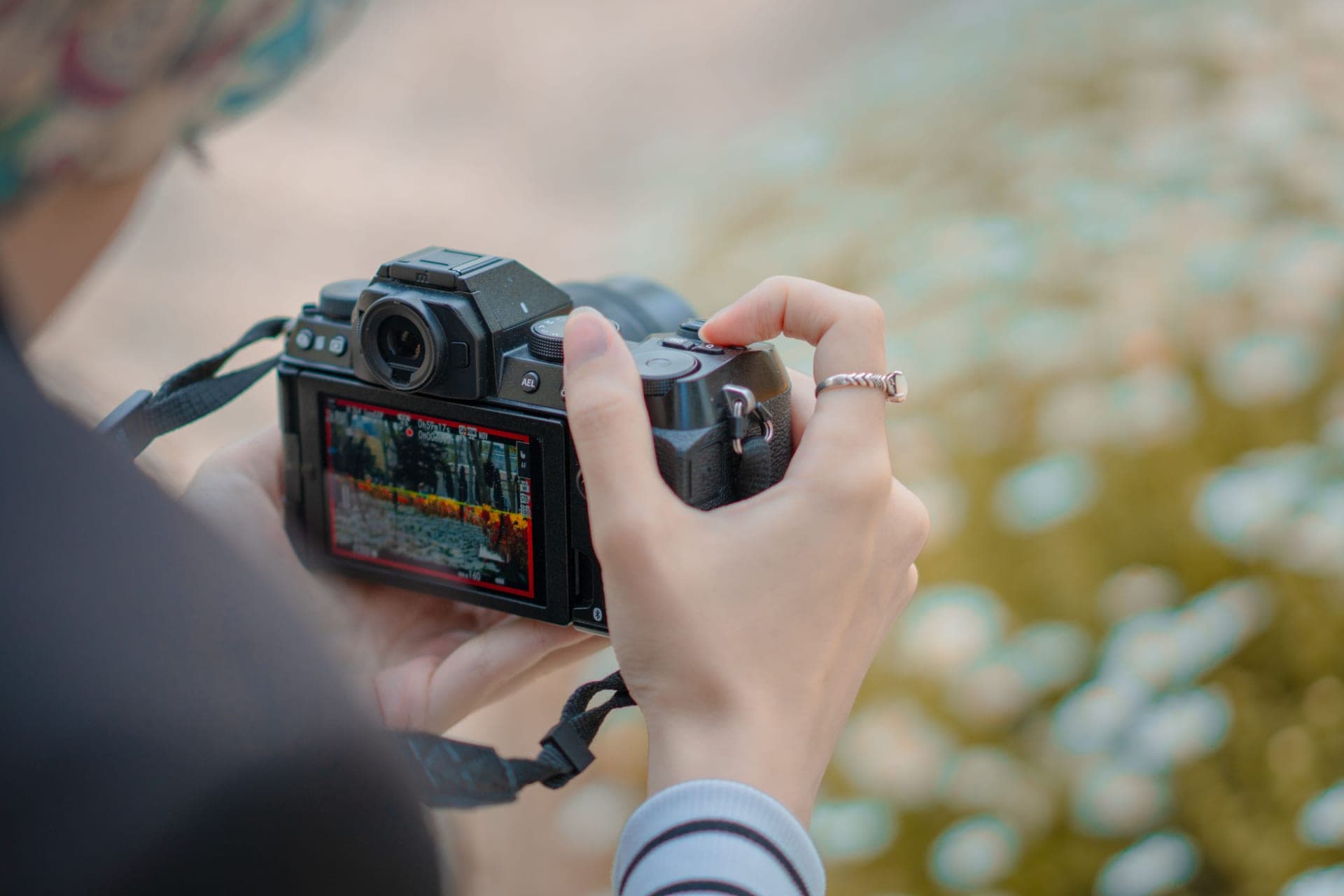 A close-up of someone adjusting camera settings outdoors