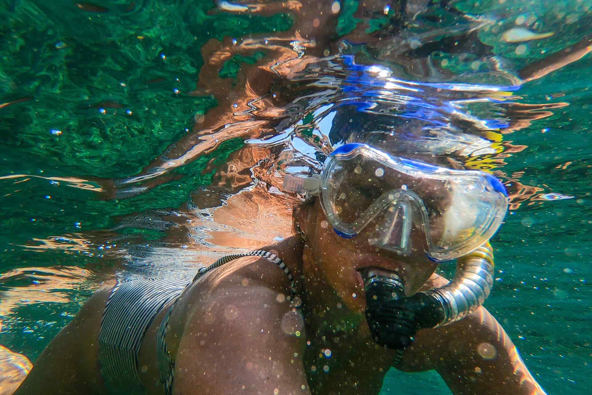 A snorkeler swimming in clear water